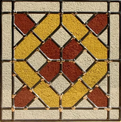 Détail d’un panneau de vitrail géométrique aux verres rouges, jaunes et bleus